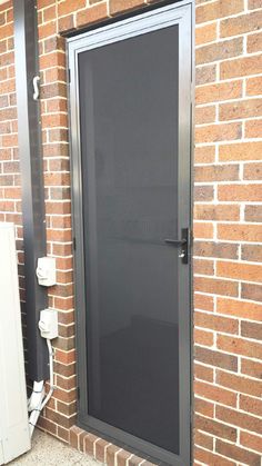 an open door to a brick building next to a heater and air conditioner