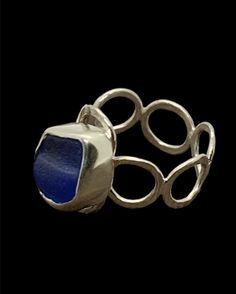 This unusual sterling silver ring features a textured cornflower blue sea glass nugget found on the west coast of Scotland. The sea glass piece is hand set within fine silver bezel setting on a hooped and hammered sterling silver band - fits UK size L-L.  Makes an ideal gift for ladies or girls, wife or girlfriend - birthday, Christmas, anniversaries.  Other similar items available: Pendants https://rocklobstersea glass.etsy.com?section_id=24274610 Rings  https://rocklobstersea glass.etsy.com?se Modern Handmade Stackable Rings As Gift, Unusual Rings Design, L Ring, Unusual Rings, Anniversary Gift For Wife, Band Fits, Blue Sea Glass, Girlfriend Birthday, Birthday Gifts For Best Friend