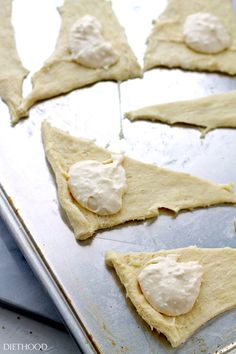 some food that is laying out on a baking sheet in the process of being made