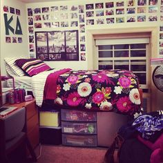 a bed room with a neatly made bed and lots of pictures on the wall