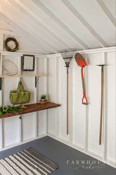 a room with white walls and shelves filled with gardening tools