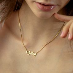 "Name Necklace, 14K Gold Color Name Necklace, Box Chain Necklace Personalized Handmade Silver Script Name Necklaces crafted with love from solid sterling silver in TEXAS. DETAILS Personalized Gold Name Necklaces, 100% 14k Gold Plated, Sterling Silver, or Rose Gold Plated The necklace can be personalized with NAME, NUMBER, WORD Name size - lowercase letters are approximately 7 mm and uppercase letters are approximately 10 mm PERSONALIZATION See font sample at last image AT CHECK OUT Leave a note Silver 14k Gold Name Necklace For Anniversary, Personalized Gold Jewelry With Box Chain, Gold Box Chain Necklace For Mother's Day, Personalized Gold Box Chain Jewelry, Mother's Day Gift Jewelry Box Chain, Mother's Day Gift Box Chain Jewelry, Minimalist Necklace With Box Chain For Anniversary, Minimalist Box Chain Necklace For Anniversary, Gold Nameplate Jewelry With Box Chain