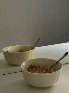 two bowls filled with oatmeal sitting next to each other on a counter