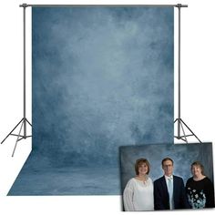 two people are standing in front of a blue backdrop with an image of them on it