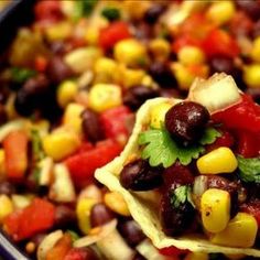 a tortilla filled with black beans, corn and cilantro