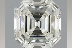 an emerald cut diamond on a gray background with the center stone in white and black