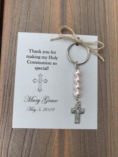 a keychain with a cross on it and a thank card attached to it