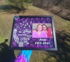 a purple and black frame with two women on it in the middle of a field