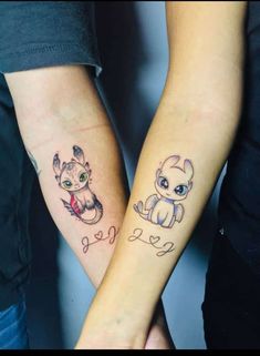 two people holding hands with tattoos on their arms and one has a small baby in the middle