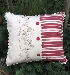 a red and white pillow sitting on top of a tree