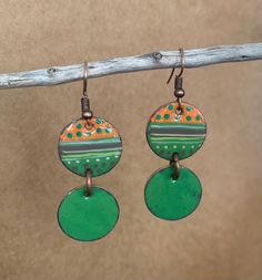 Handmade earrings using copper pennies, hand fired enamel, with hand painted design and resin to seal. Hand Painted Green Copper Jewelry, Modern Hand Painted Green Copper Jewelry, Modern Green Hand Painted Copper Jewelry, Hand Painted Copper Artsy Earrings, Hand Painted Artsy Copper Earrings, Artsy Hand Painted Copper Earrings, Artistic Hand Painted Copper Earrings, Green Artisan Enamel Earrings, Artisan Green Enamel Earrings