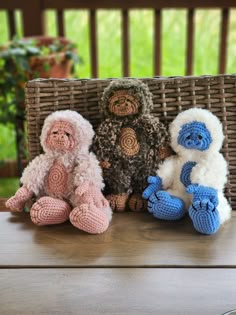 three crocheted stuffed animals sitting next to each other on top of a table