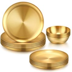 a set of gold plates and bowls on a white background