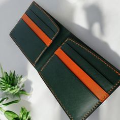 Hello and welcome. I present to you a handmade wallet made of Buttero leather (brown) and Gaucho leather (the inside of the wallet). Both leathers come from Italian tanneries. They are characterized by very high durability and unique color depth. The leather "ages" very nicely with use. The wallet has 6 pockets/slots for cards or documents and a main pocket for banknotes. The orange threads are braided, which makes them extremely durable. Additionally, the two-needle hand sewing technique means Green Leather Wallet With Card Slots, Green Leather Bifold Wallet, Green Leather Wallet With Rfid Blocking, Green Leather Wallets For Daily Use, Daily Use Green Leather Wallet, Handmade Green Leather Trifold Wallet, Green Leather Trifold Wallet, Green Leather Wallet For Gift, Green Leather Wallet As Gift