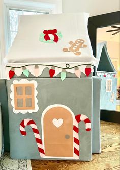 a house made out of cardboard with candy canes