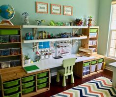 a child's room with green walls and lots of toys on the shelfs