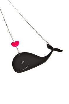 a black whale necklace with two red hearts on it's tail and a silver chain