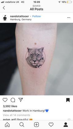 a small tattoo on the leg of a woman's arm with an image of a lion