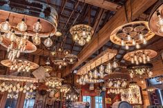 a room filled with lots of lights and chandeliers hanging from the ceiling above