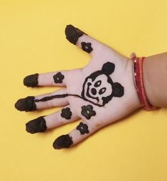 a child's hand painted with black and white designs