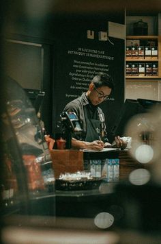 a man sitting at a counter working on his laptop