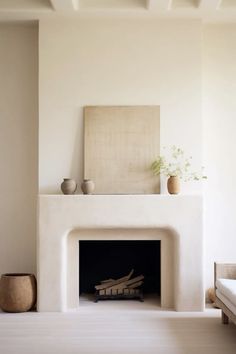 a living room with a fireplace and white walls