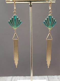 Textured Front, Hollow Back This listing is for a pair of long Art Deco style dangle earrings. They feature green and gold Czech glass beads and long lightweight brass Deco style pendants. The brass pendants have a ribbed texture on the front and they are hollow on the back (SEE 2nd PHOTO). The textured Czech beads are shaped like fans; one of the most popular design motifs during the 1920s and 1930s. The earrings measure 3 1/2 inches long and hang from gold plated lever back ear wires. ABOUT TH Green Art Deco Drop Earrings, Art Deco Green Jewelry For Pierced Ears, Green Metal Evening Earrings, Green Metal Earrings For Evening, Retro Green Drop Earrings, Retro Green Earrings For Party, Green Retro Party Earrings, Green Metal Art Deco Jewelry, Retro Green Jewelry For Evening