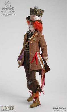 a doll dressed up as a clown with an orange hair and red wig is standing in front of a white background