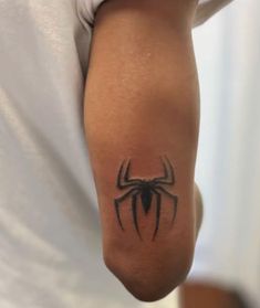 a person with a spider tattoo on their arm