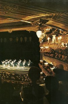 a group of people standing on top of a stage next to each other in front of an audience