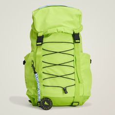 a neon green backpack sitting on top of a white surface