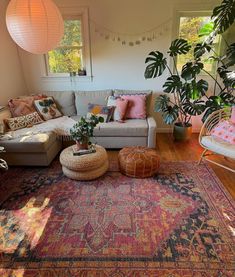 a living room filled with furniture and lots of plants