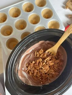 there is a chocolate cake in the crock pot and muffin tins on the table