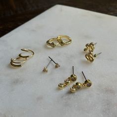 Our Snake Huggies have the reputation of being a showstopper. Featuring pavé details and green stones, these huggie earrings will put all eyes on you. For a stunning ear stack, layer these gold huggies with our Girl Boss Earrings and Snake Stud Earrings. Adjustable Gold Stackable Earrings, One Ear Piercing, Uncommon James, Gold Huggies, Seeing Double, Double Earrings, Green Stones, Ear Stack, Spiral Earrings