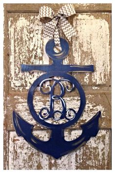 an anchor with the letter b on it is hanging on a wooden door that says, aka dot pot