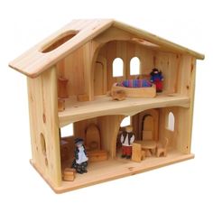 a wooden doll house with furniture and accessories