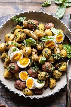 a bowl filled with potatoes and boiled eggs