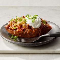 a close up of a plate of food on a table with a fork and knife