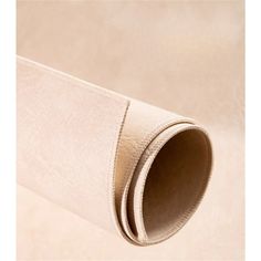 a roll of white leather on a beige background