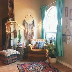 a living room filled with furniture next to a window covered in curtains and string lights