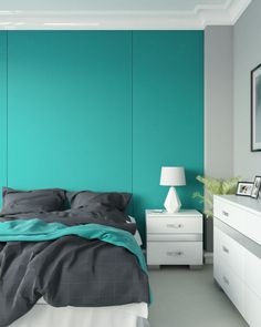 a bedroom painted in teal and white with a bed, nightstands, and chest of drawers