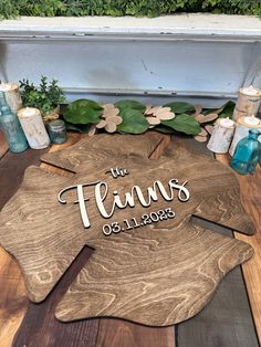 the personalized wooden star is surrounded by candles and greenery