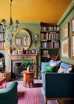 a living room filled with furniture and bookshelves next to a fire place in front of a fireplace