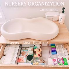 an organized drawer with baby items in it and the words nursery organization written above it