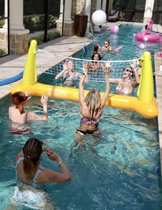 some people are playing volleyball in a pool with an inflatable volley ball net