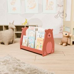 there is a book stand with books in it on the floor next to a teddy bear