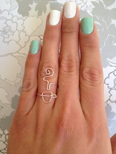 a woman's hand with two rings on it and the word love written in white