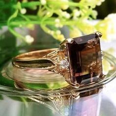 4.88 Carat Natural Brown Topaz & Diamonds 14k Solid Gold Ring Ring Material: 14k Solid Gold  Total Metal Weight: 3.8 Grams  Gemstone: Natural Smoky Topaz Gemstone Color: Brown Gemstone Shape: Emerald Gemstone Dimensions: 11.00x9.00 mm Gemstone Quantity: 1 Gemstone Carat Weight: 4.80 Carat Diamonds: Natural Round Shaped  Diamonds Quantity: 2 Diamonds Total Carat Weight: 0.08 Carat Total Carat Weight: 4.88 Carat Ring Quantity: One Ring Condition: New Made in the USA Delivered in an elegant gift box 💜Please do not hesitate to ask any questions and we will be happy to assist You 💜 Brown 14k Gold Fine Jewelry Ring, Brown 14k Gold Rings Fine Jewelry, Fine Jewelry 14k Gold Brown Ring, Heirloom 14k Gold Diamond Ring With Accent Stones, Timeless Gold Diamond Ring With Accent Stones, Elegant Topaz Ring With Accent Stones In 14k Gold, Elegant Rectangular Topaz Ring In 14k Gold, Elegant 14k Gold Rectangular Topaz Ring, Elegant 14k Gold Topaz Ring With Accent Stones