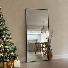 a christmas tree sitting in front of a mirror