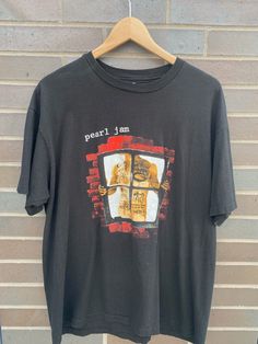 "Vintage 1990s Pearl Jam Window Pane/ Pain Graphic / Vintage T-Shirt / Single Stitch / Music Promo Print / Concert / Tour / Retro Style - Fits like a L (Length 27\", Chest 21\") - Missing tag - Pearl Jam Window Pain concert tour tee with Canadian stops on the back - Overall great vintage condition (no holes/no stains) - Message for more information Please take note of the measurements listed as these are vintage clothes and may fit different than the tag size. Follow our page for more vintage clothing drops! Connect with us on Instagram: @recurarchives" 90s Letter Print Tops For Music Festivals, 90s Style Letter Print Tops For Music Festivals, 90s Style Tops With Letter Print For Music Festivals, '90s Style Letter Print Tops For Music Festivals, 90s Band Logo T-shirt For Music Festivals, 90s Band Logo Crew Neck Top, 90s Band Logo Tops With Crew Neck, 90s Style Concert T-shirt With Screen Print, 90s Band Logo Cotton T-shirt